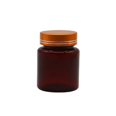 Botella de plástico de forma redonda de 100 cc de color ámbar/marrón con tapa de aluminio para cápsulas/píldoras
